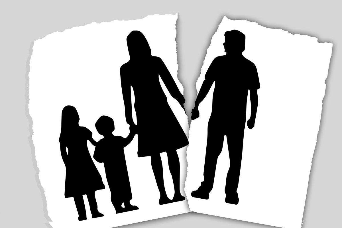 Torn Black and White image of a family with father on one side